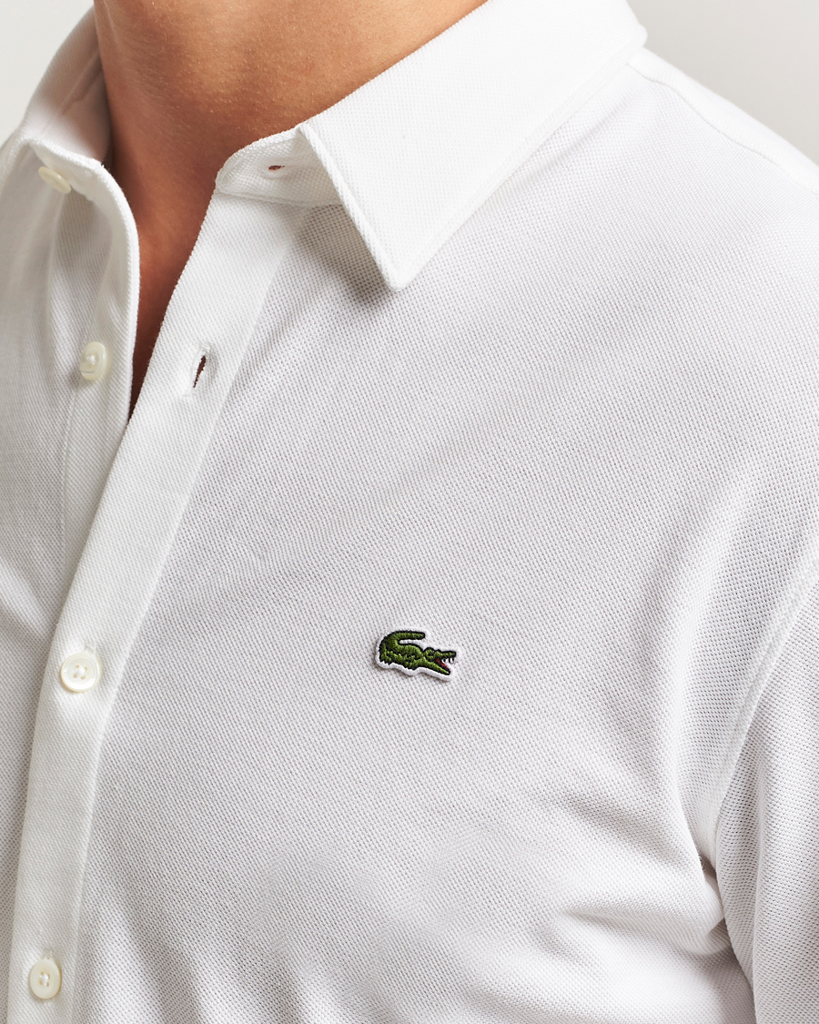 Lacoste Slim Fit Cotton Piqu Shirt White at CareOfCarl.com Lacoste Slim Fit Cotton Piqu Shirt White at CareOfCarl.com